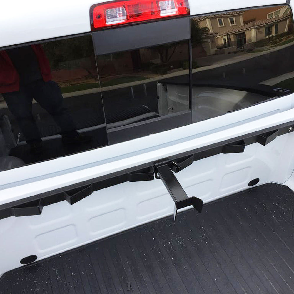 Offset Wheel Chock installed on the Bed Buddy Motorcycle Tie Down Rack in a white truck.