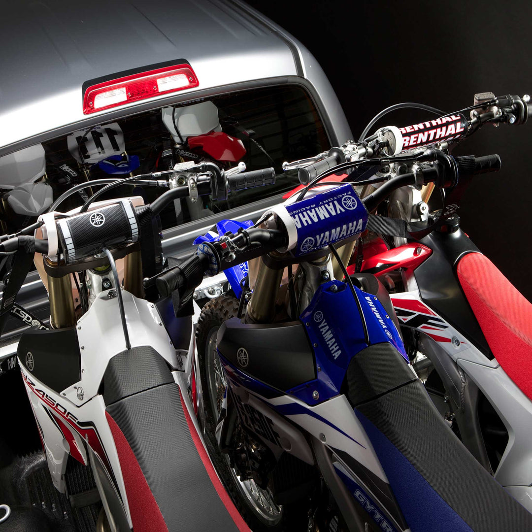 This image shows three motorcycles with clearance from the handlebars using the Offset Wheel Chock.