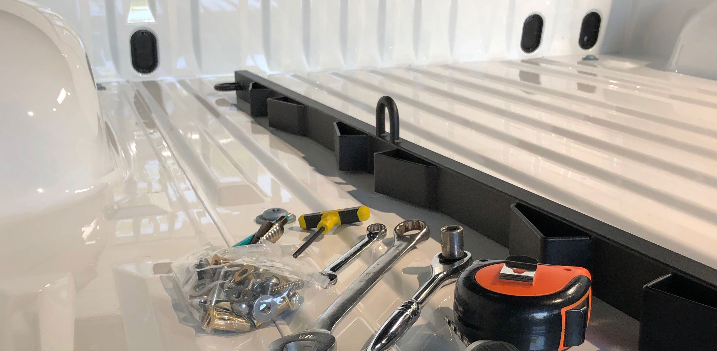 A Bed Buddy Moto Rack and installation tools in the bed of a truck awaiting installation.