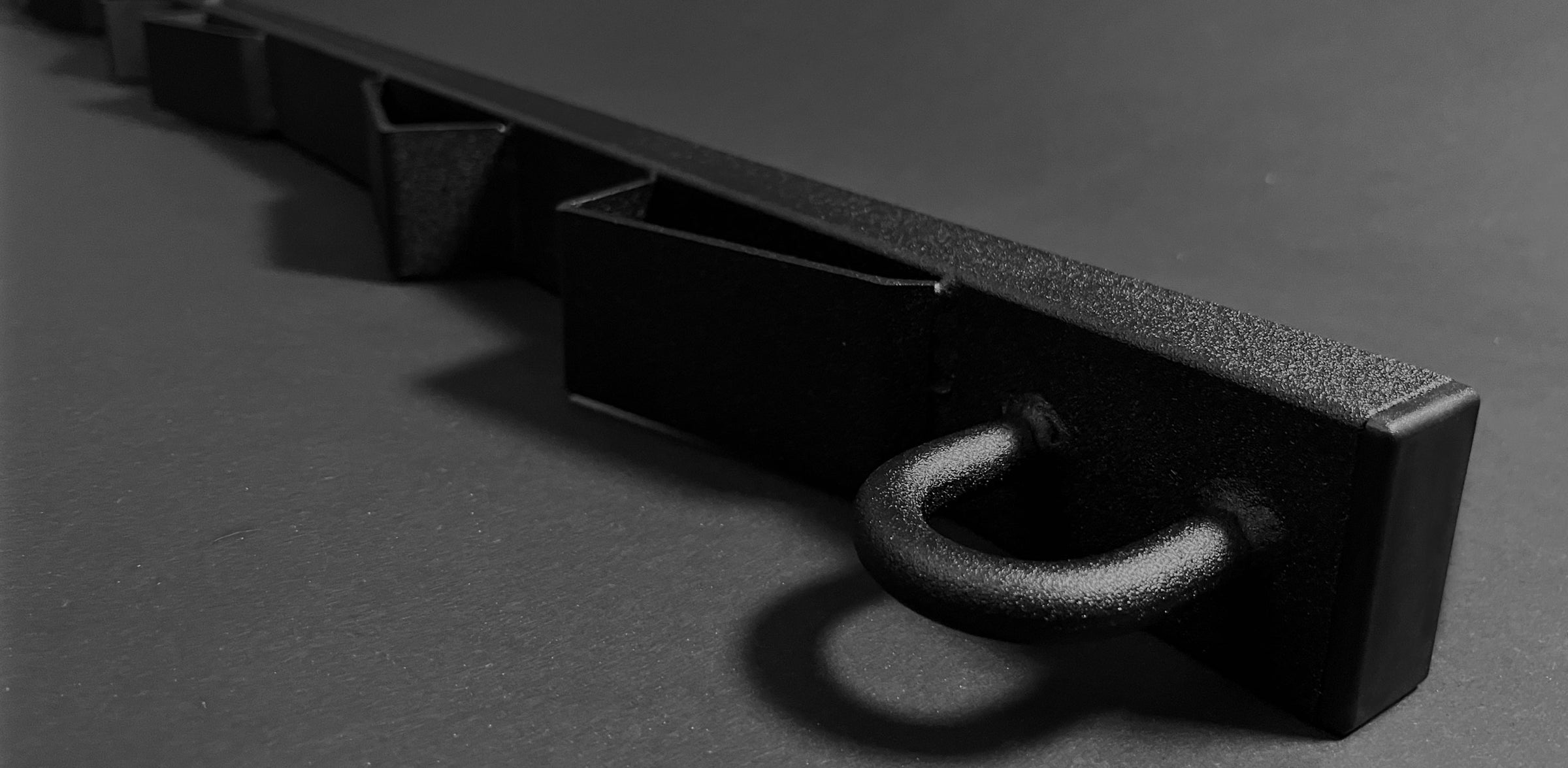 Detailed image of the Bed Buddy Moto Rack on a dark background.