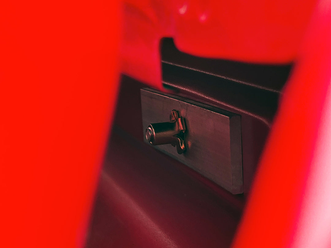 Close-up view of the Chevrolet / GMX Truck Bed Backing Plate installed between the bed and the cab of a Chevy Silverado truck.