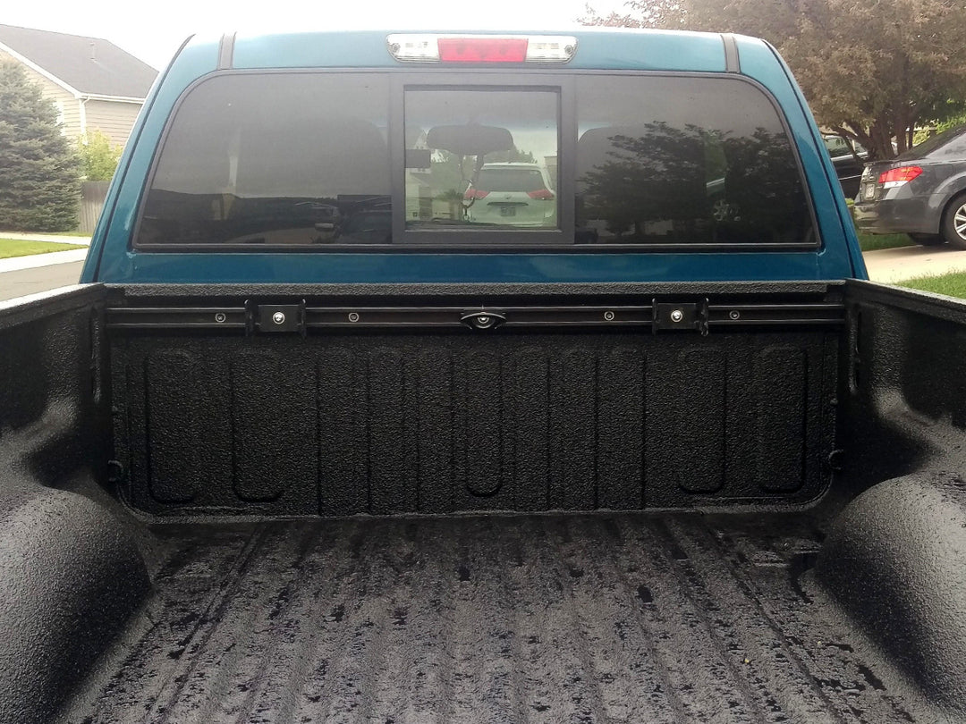 A motorcycle tie down support rack mounted in a truck bed.