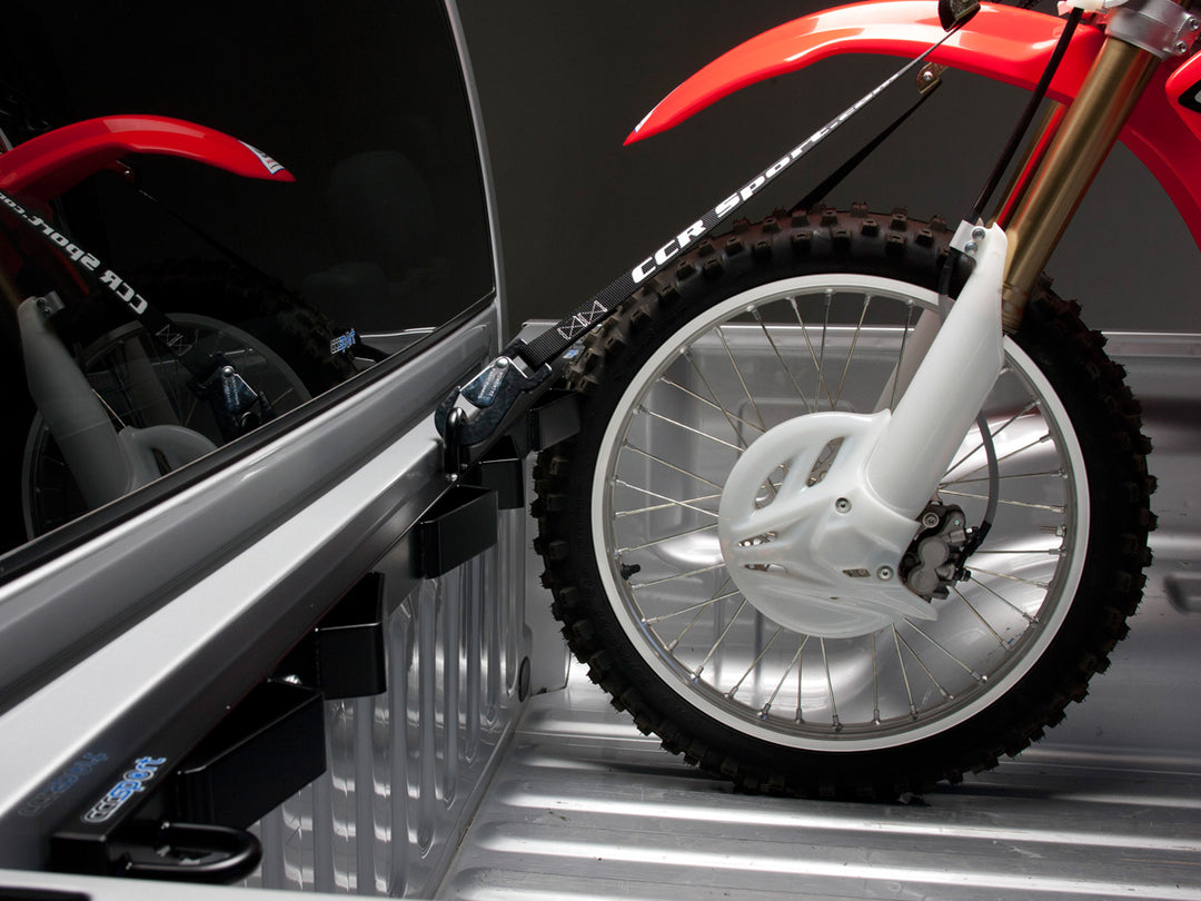 A Dodge Ram truck outfitted with the Bed Buddy Moto Rack featuring a Honda motorcycle.