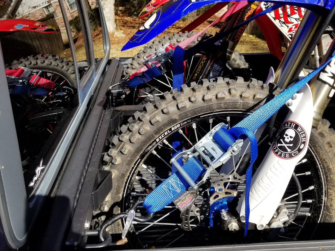 Three full-size motorcycles tie down securely with the Bed Buddy Moto Rack in the bed of a Ford F150.
