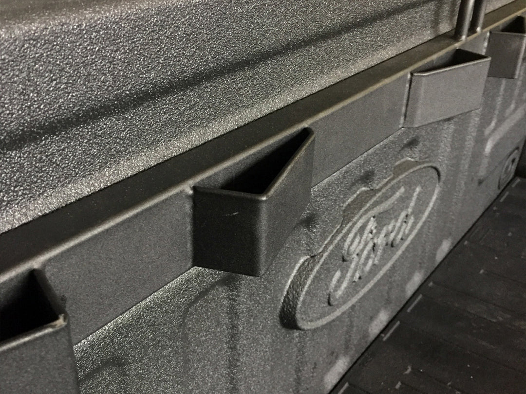 A close-up of the Bed Buddy Moto Rack mounted into the bed of a Ford F150.