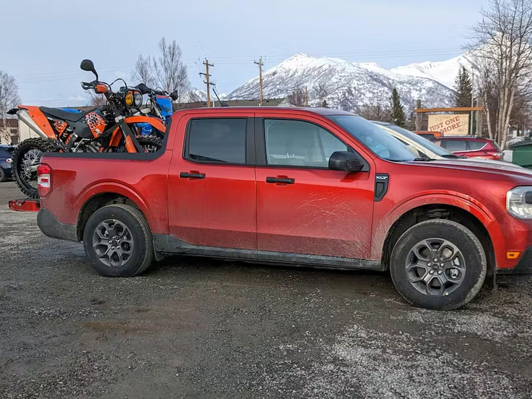 Two dirt bikes loaded into the bed of a Ford Maverick and supported with a CCR Sport Moto Rack.