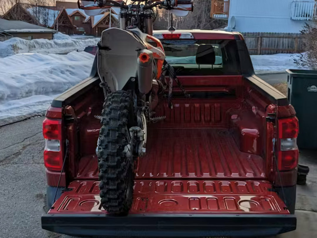 A Ford Maverick truck with a Hybrid Moto Rack supporting a KTM dirt bike.