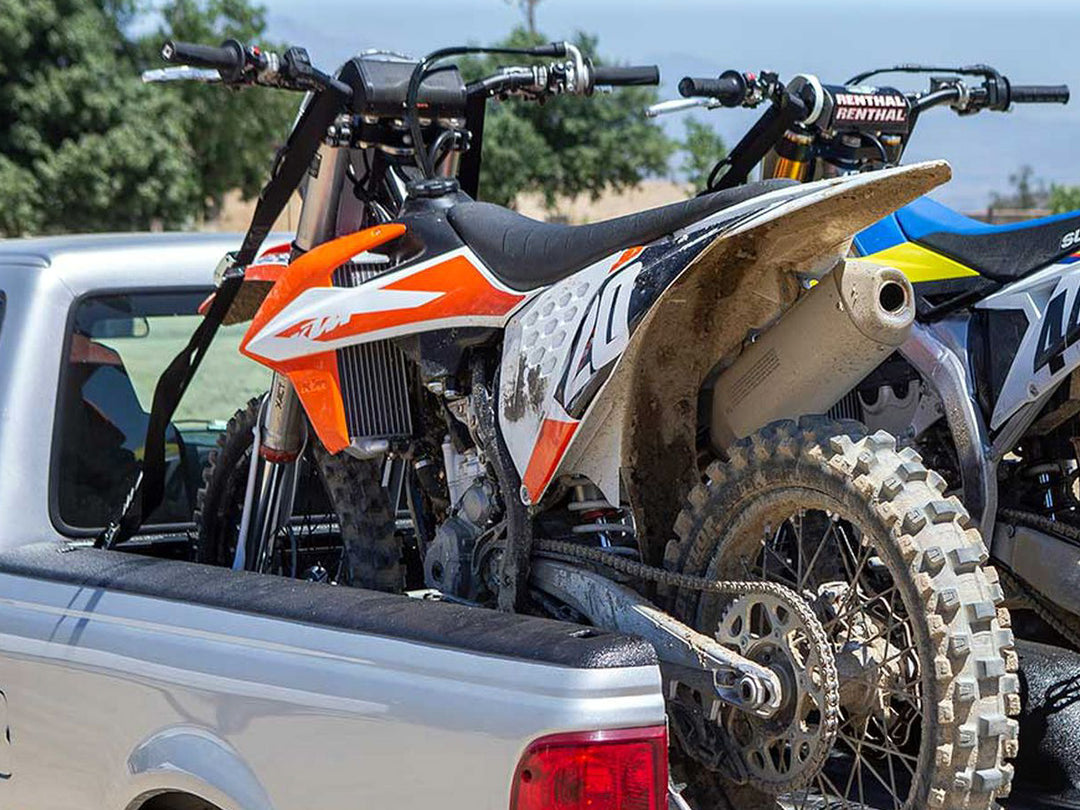 Two motocross dirt bikes loaded into the bed of a Ford Ranger truck with a CCR Sport moto rack.