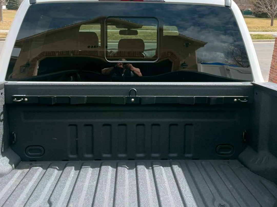 A Ford Super Duty pickup with the CCR Sport Bed Buddy installed to the bulkhead.
