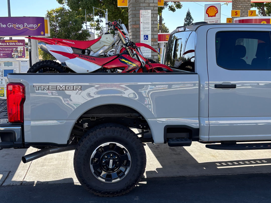 Ford Super Duty Tremor with CCR Sport truck bed moto rack carrying two Honda dirt bikes.