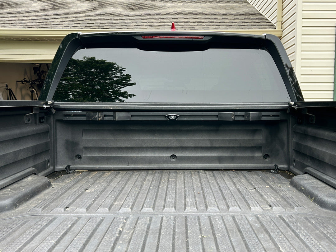 CCR Sport motorcycle transport mounting system installed along the front wall of a Honda Ridgeline truck bed.