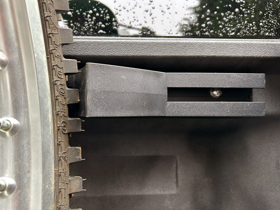 Off-road motorcycle wheel secured in a Honda Ridgeline truck bed using a CCR Sport motorcycle transport system.