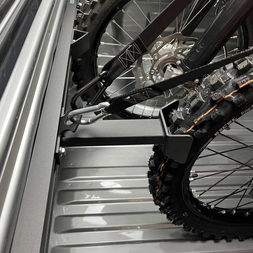 Hybrid Offset Wheel Chock offsetting a motorcycle or transport in a truck bed.