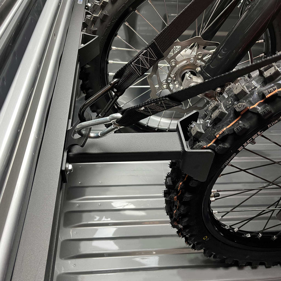 Hybrid Offset Wheel Chock offsetting a motorcycle or transport in a truck bed.