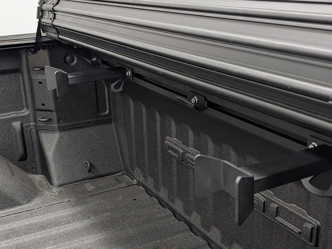 Truck bed with a roll-up bed cover with the Hybrid Moto Rack equipped with two offset motorcycle wheel chocks.