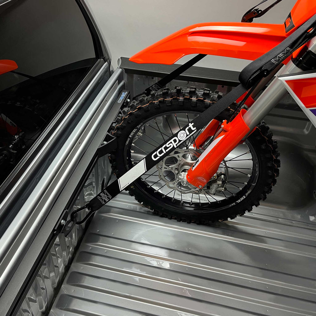 A single KTM dirt bike motorcycle tie down securely to the Hybrid Moto Rack for 1 bike.