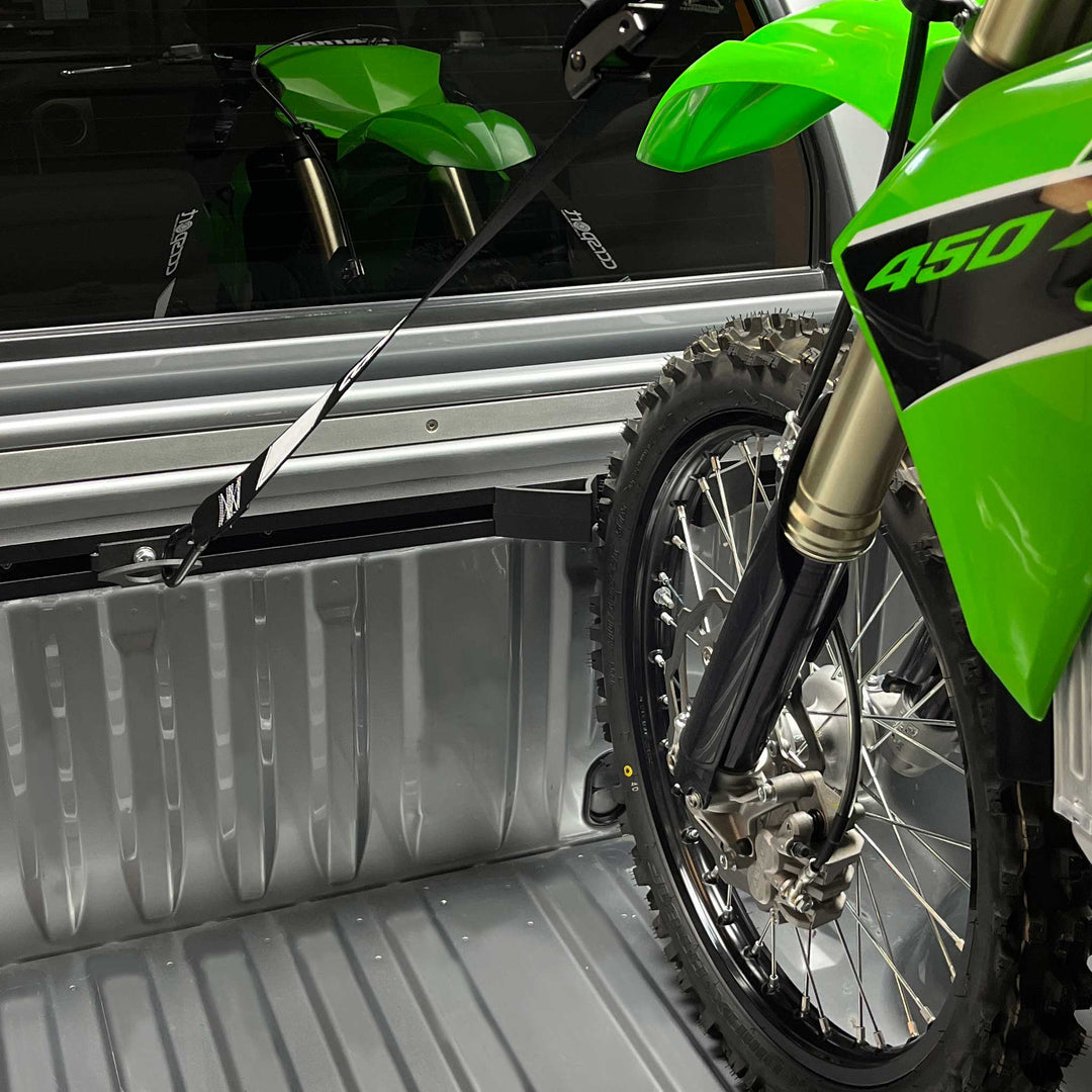 A Kawasaki KX450 motocross bike strapped securely to the Hybrid Moto Rack.