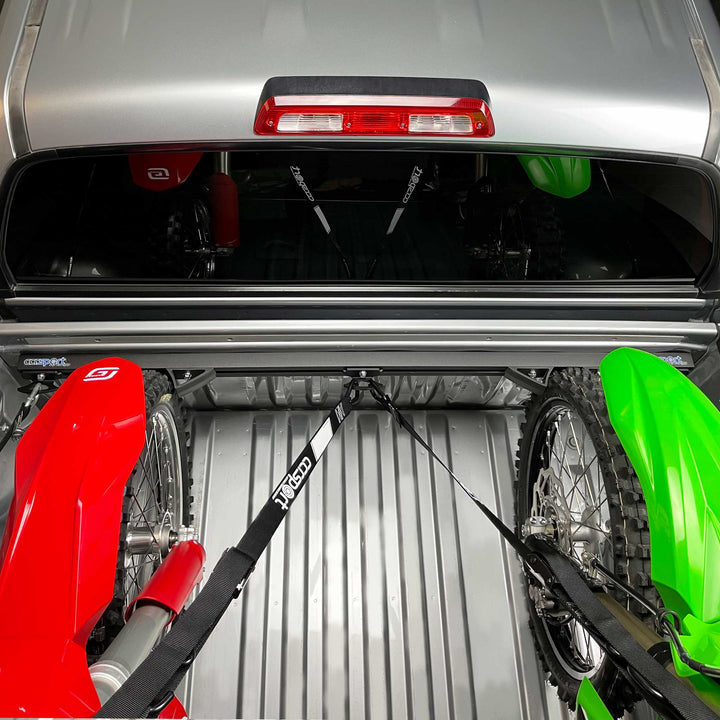 A top view that shows two dirt bikes tie down to the Hybrid Moto rack ready for transport in a truck.