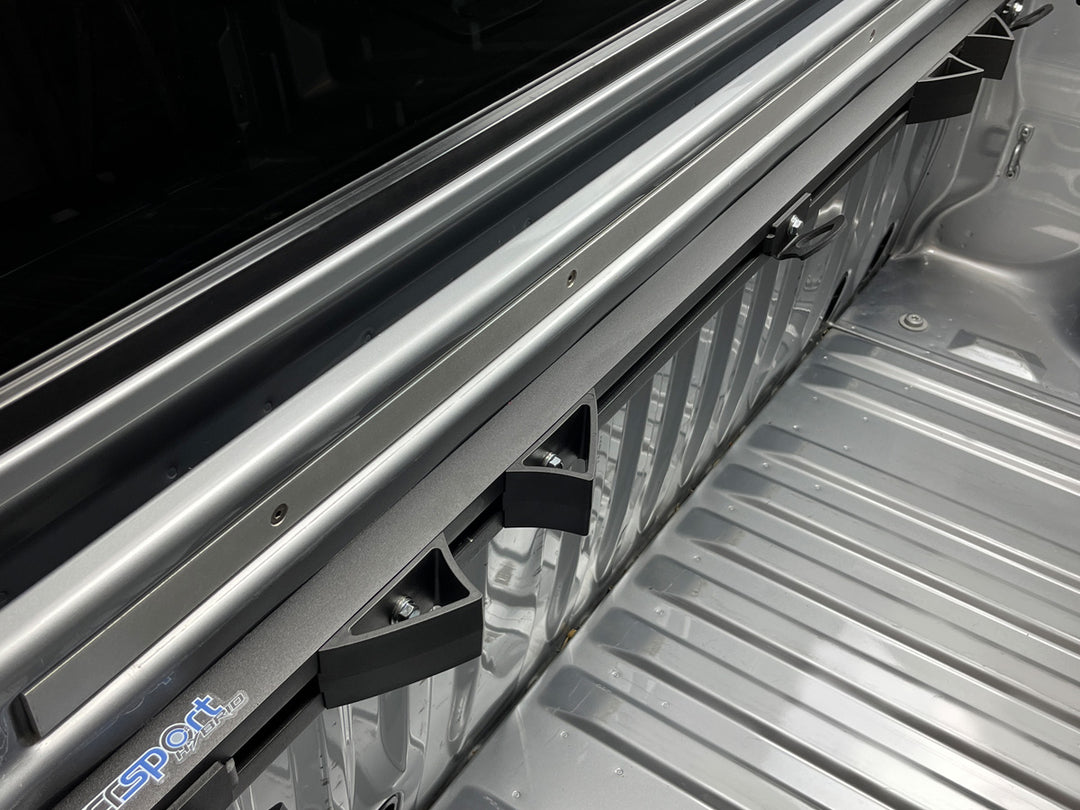 An above side view of the Hybrid Moto Rack mounted in the bed of a silver truck.