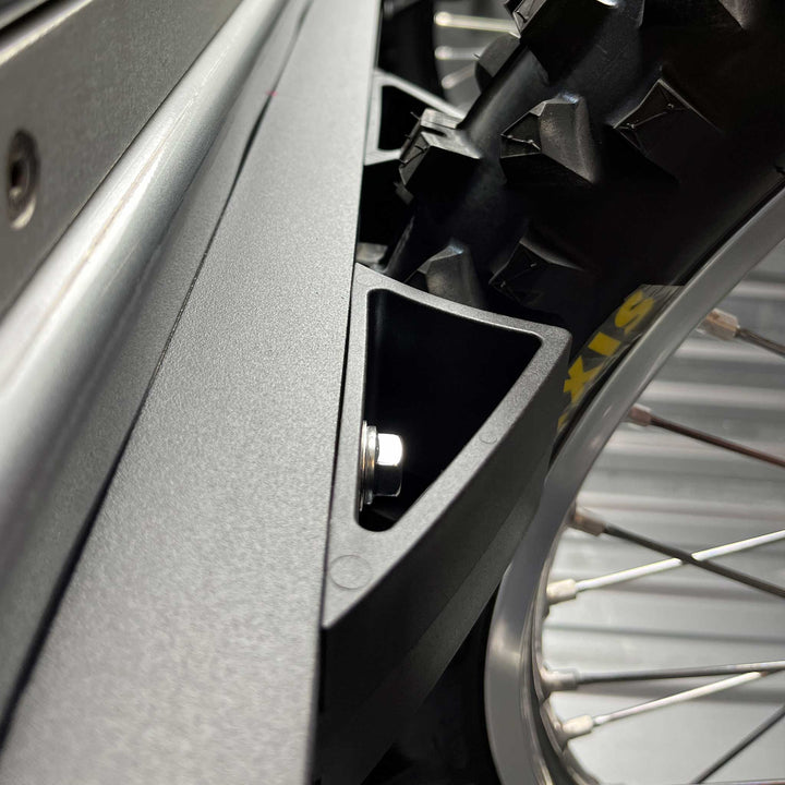 Hybrid Micro Moto Rack installed in truck bed showing wheel chock with dirt bike tire in chock