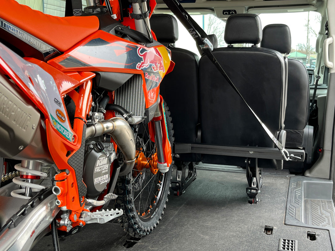 Redbull KTM motocross bike strapped into a van with the CCR Sport Hybrid Moto Van Rack.