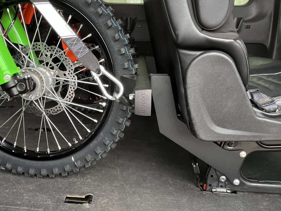A Hybrid Moto Van Rack mounted to the rear passenger seat with motorcycles secured for transport.