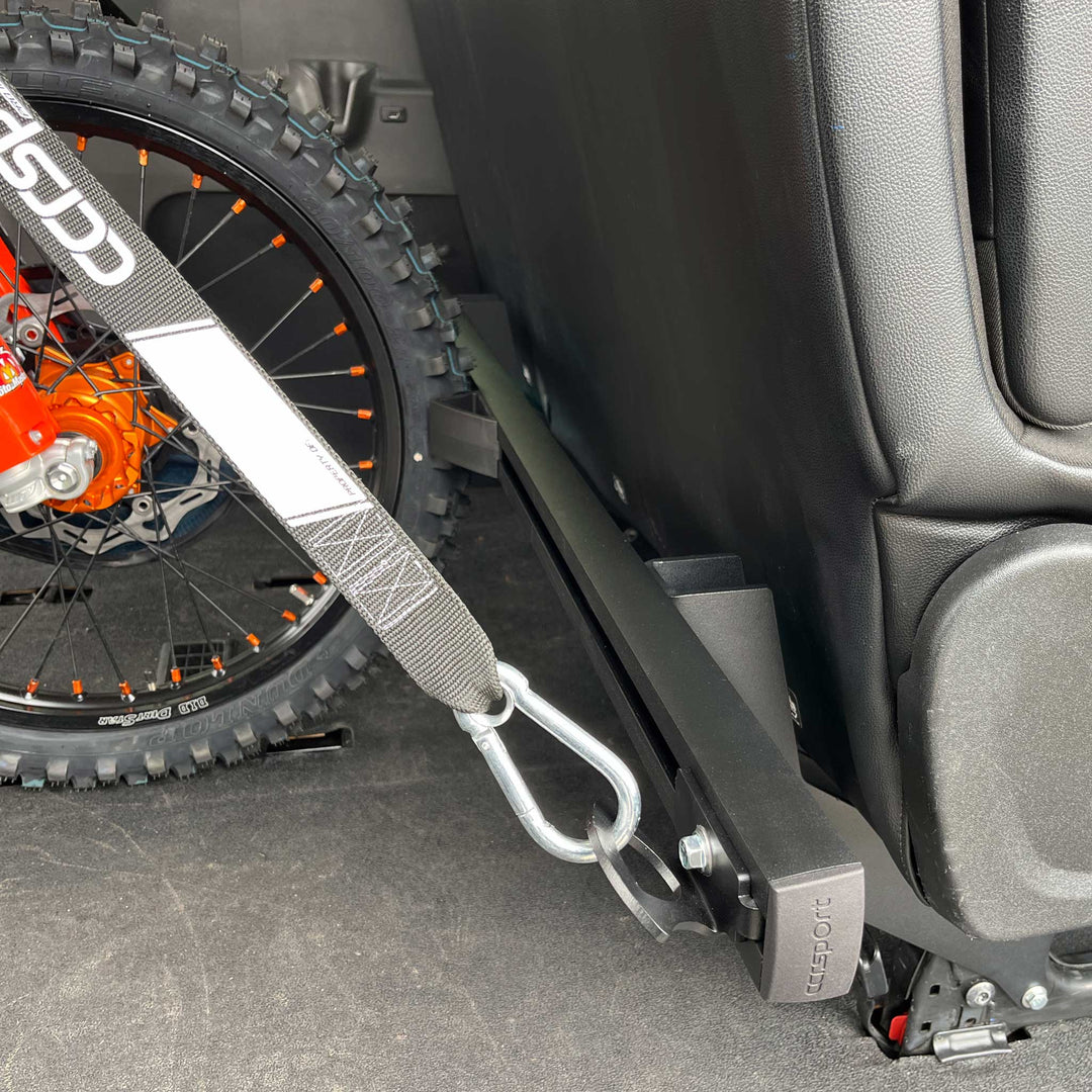Close-up of Hybrid Moto Van Rack mounted to rear passenger seat of a Mercedes Sprinter.