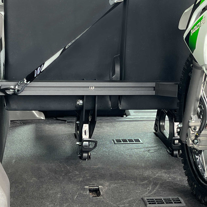 A Kawasaki 140R strapped down to the Hybrid Moto Rack in a Mercedes Sprinter passenger van.