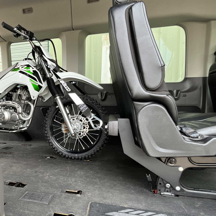 Side view of a Kawsaki KLX 140R secured to the Hybrid Moto Van Rack in a Mercedes Sprinter van,