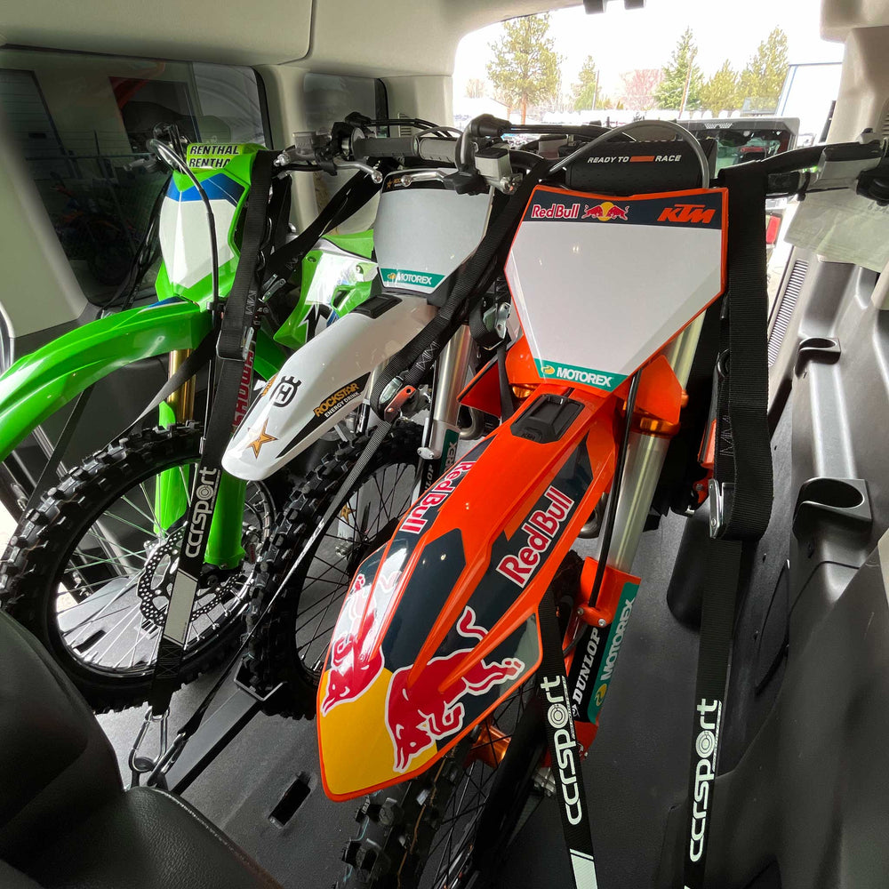This image shows three full size dirt bikes loaded into the Ford Transit using the Hybrid Moto ack X3.