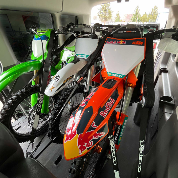 This image shows three full size dirt bikes loaded into the Ford Transit using the Hybrid Moto ack X3.
