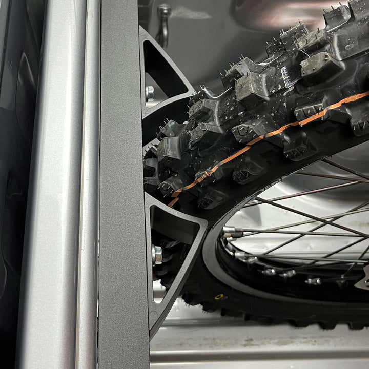 Top view of the Moto Vise wheel chock featuring a dirt bike knobby tire fitting in the chock.