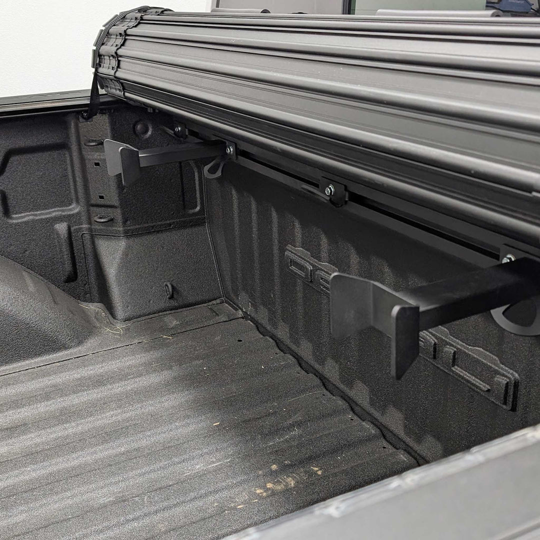 Image showing two Hybrid Offset Wheel Chock with a roll-up truck bed cover.