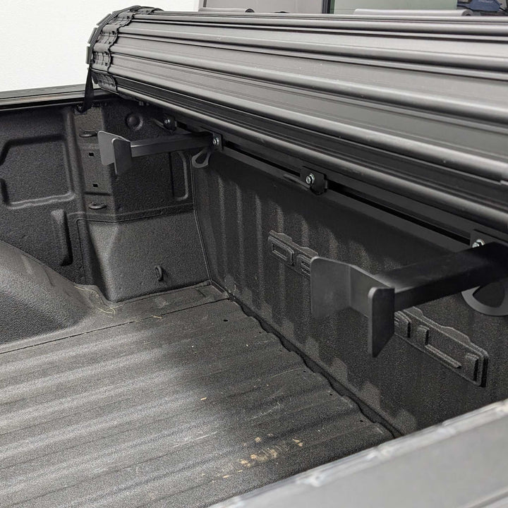Image showing two Hybrid Offset Wheel Chock with a roll-up truck bed cover.
