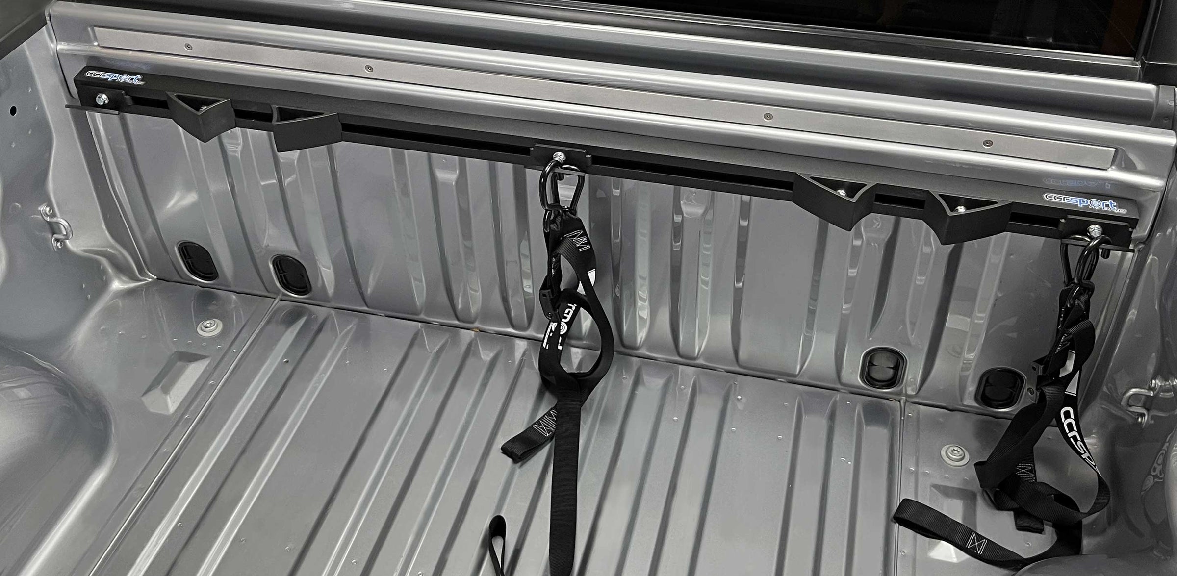 Truck bed with moto rack and straps.