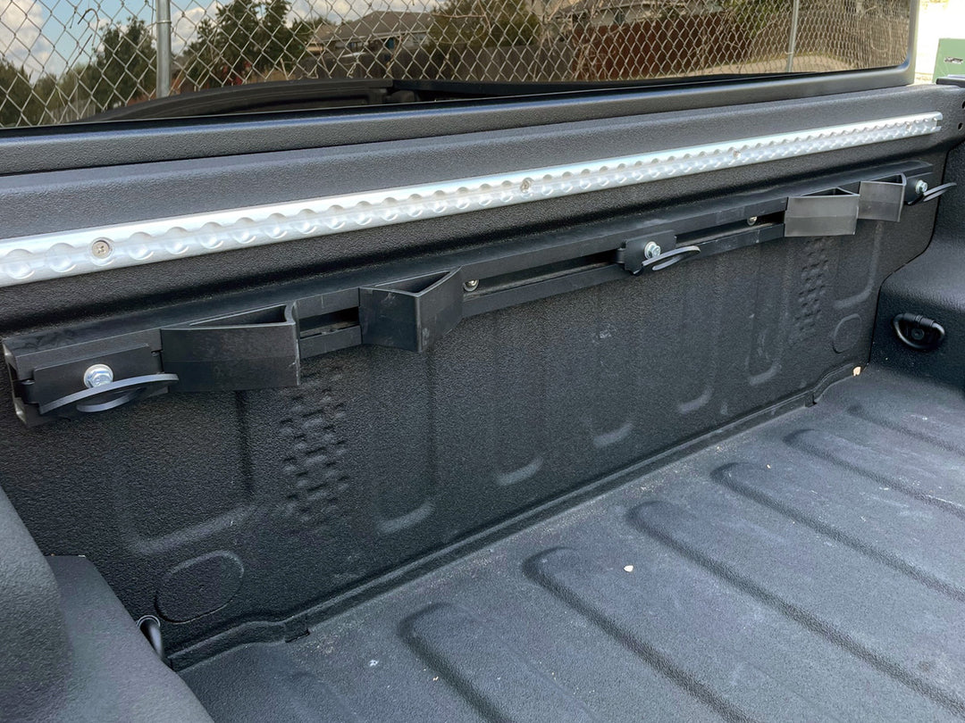 CCR Sport motorcycle transport mounting system installed along the front wall of a Jeep Gladiator truck bed.
