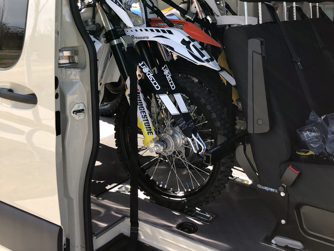 Close-up image of motorcycles tied down the a CCR Sport van moto rack in a Mercedes Sprinter van 144.