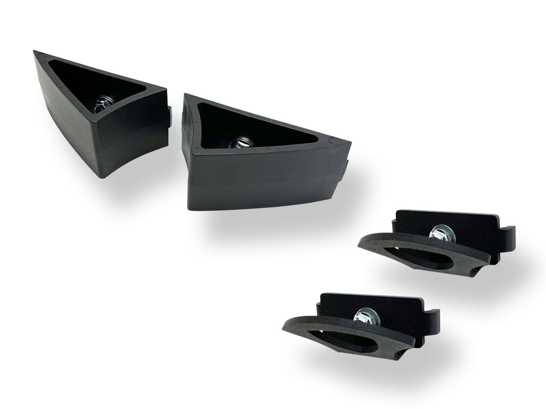 Studio photo of a Moto Vise wheel chock and two Hybrid Tie Down Anchors on a clean white background.