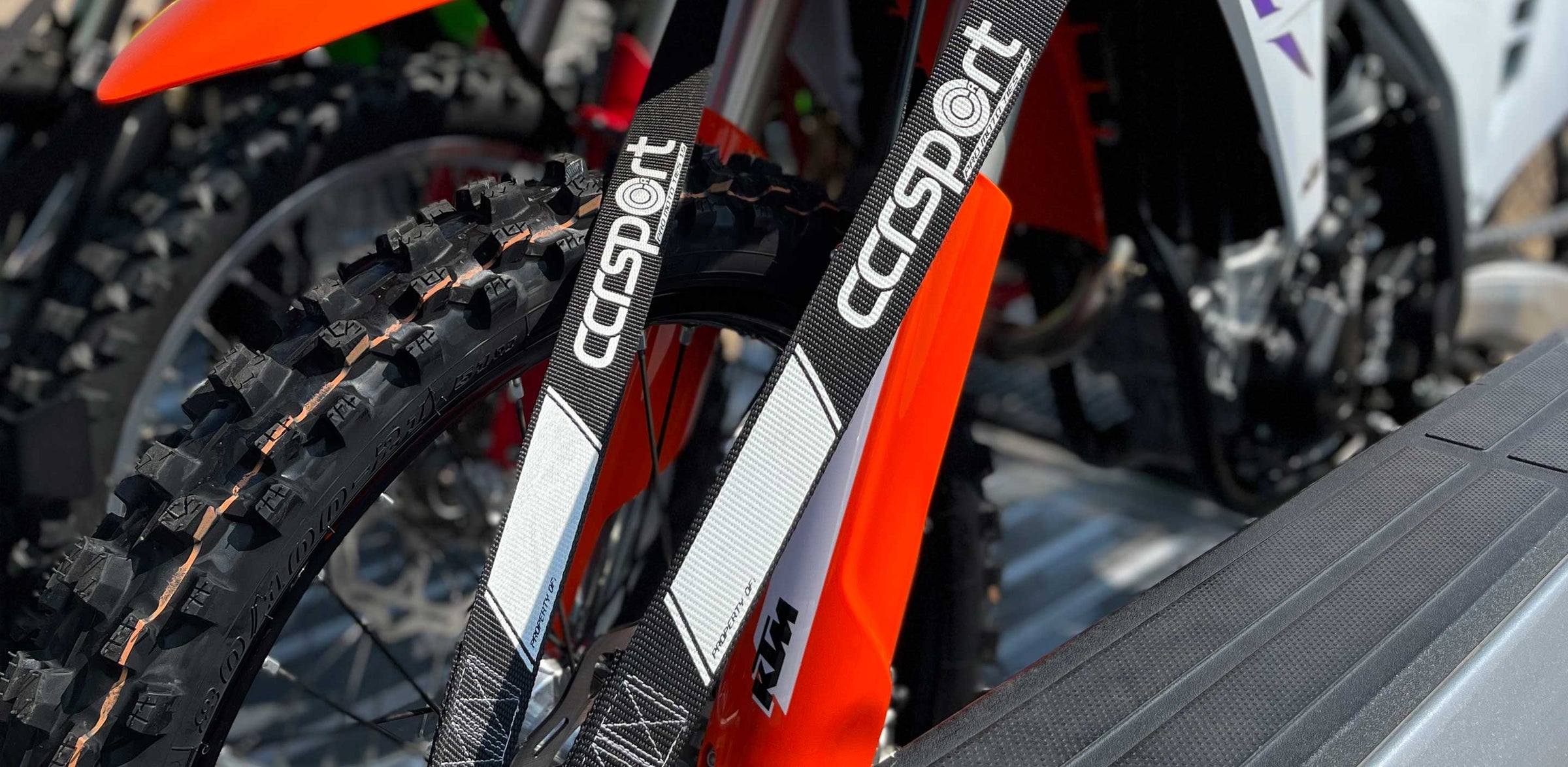 Detail photo of two CCR Sport tie down straps securing a motorcycle.