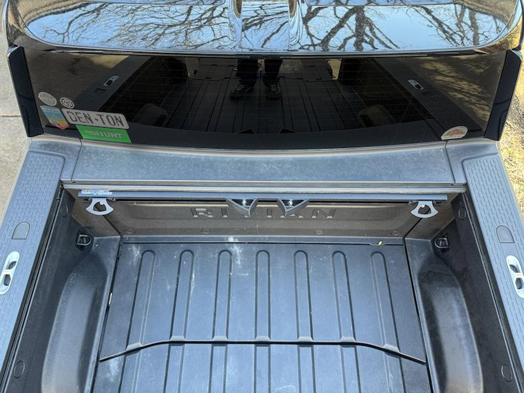 A top-down view of the CCR Sport Hybrid motorcycle tie sown rack system installed in the bed of a Rivian truck bed.