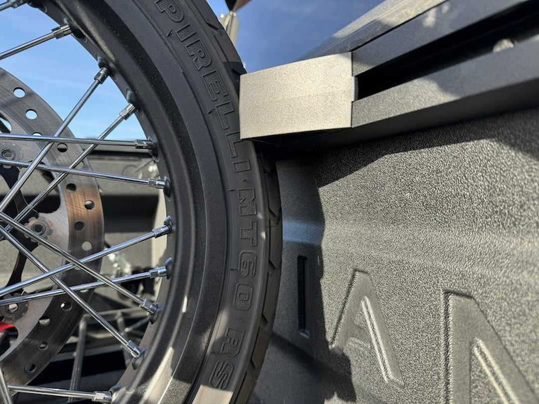 A close-up detail shot of the Hybrid Moto Vise wheel chock supporting the front tire of a street bike motorcycle.