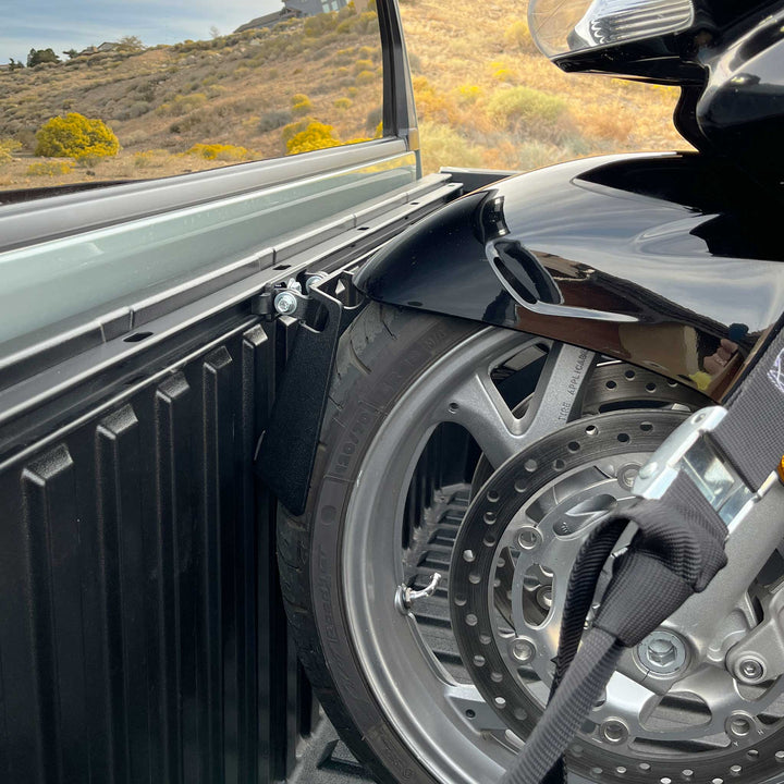Photo of a street cruiser motorcycle with a wide front tire fitting into the pivot wheel chock.