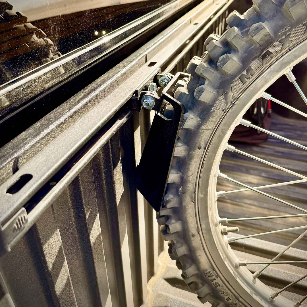 Sidw view of the Toyota Deck Rail chock supporting a dirt bike knobby tire.