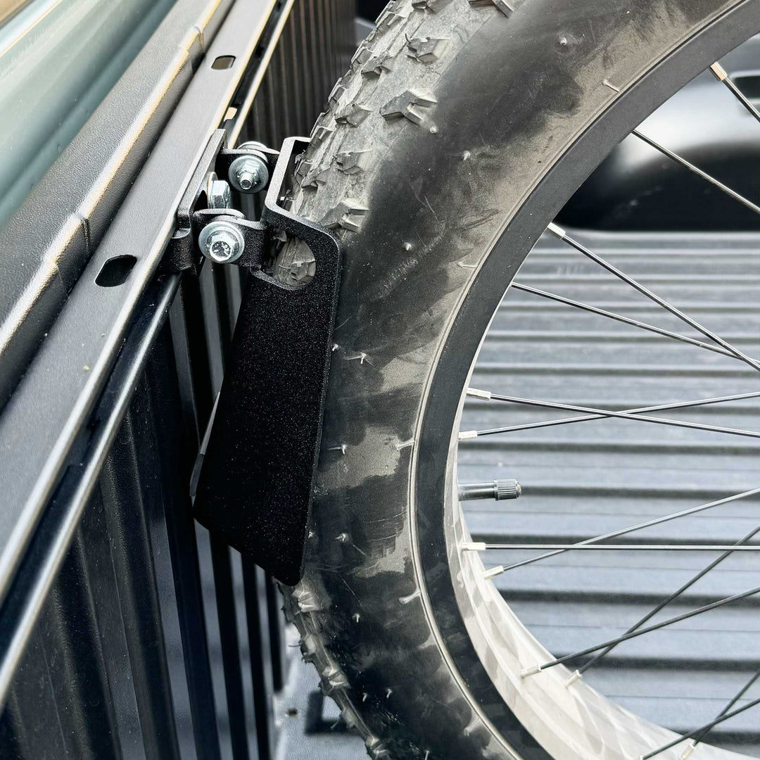 Side image of a fat tire ebike tire supported by the Toyota Deck Rail Pivot Chock.
