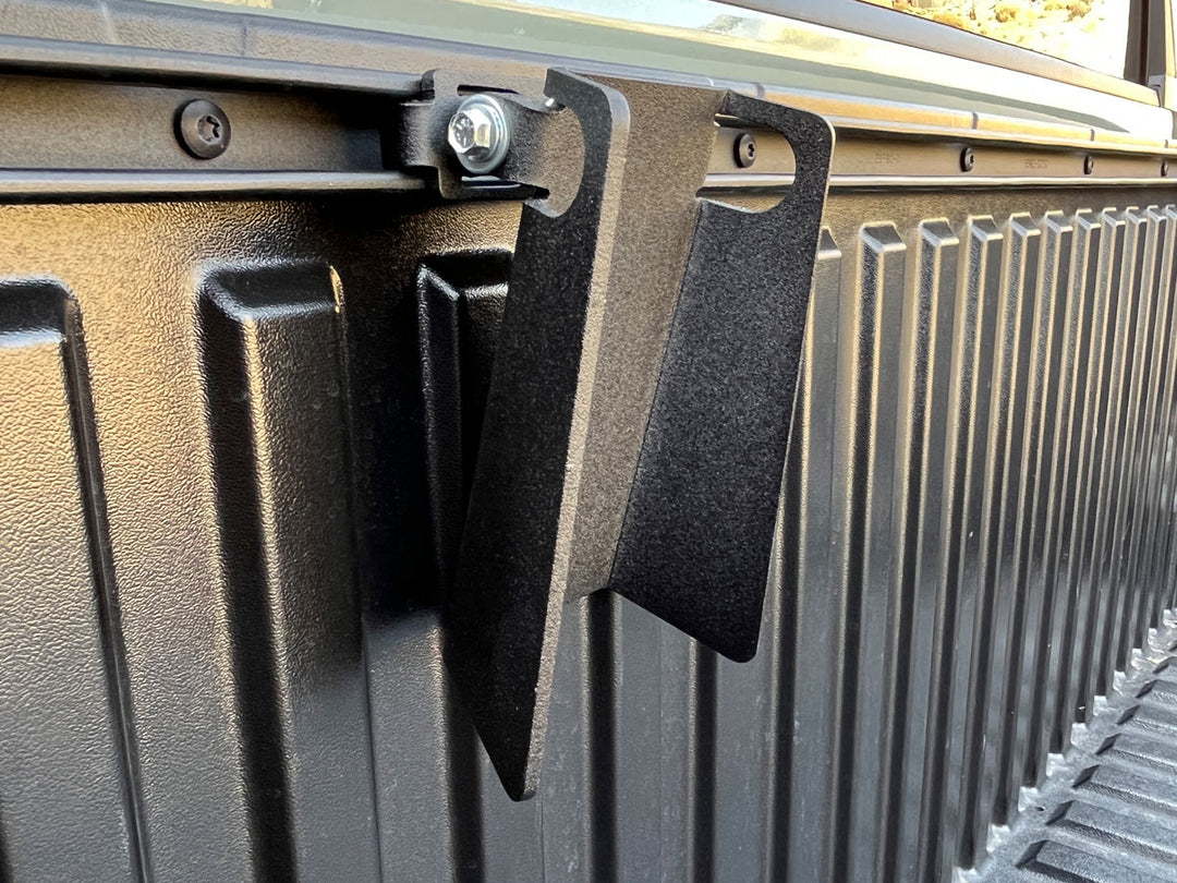 Close-up photo of the CCR Sport Toyota Pivot Wheel Chock mounted to the deck rail cargo system.