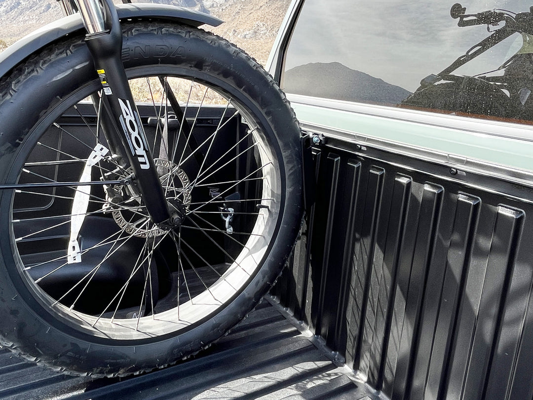 Toyota Deck Rail motorcycle wheel chock stabilizing an ebike front tire.