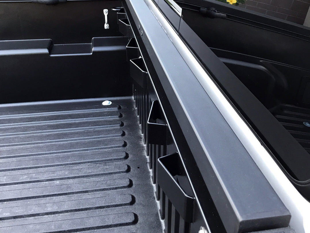 The Bed Buddy motorcycle tie-down rack installed in a Toyota Tacoma truck.