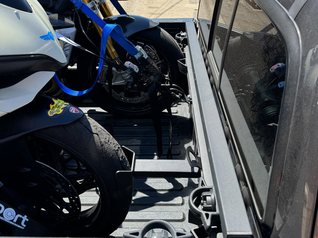 The Hybrid Moto Rack installed in a Toyota Tacoma with two sport bikes loaded securely.