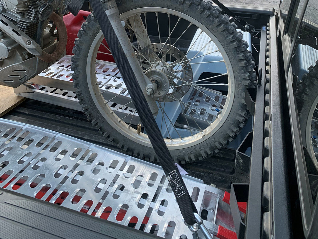 The CCR Sport Bed Buddy moto rack shown with a motorcycle tie down in the bed of a pickup truck.