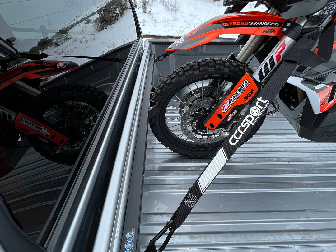 A KTM adventure motorcycle secured to the Hybrid Moto Rack in the bed of a truck.